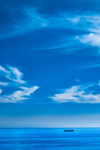 Scenic view of sea against blue sky