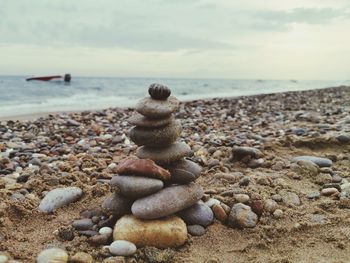 Rocks on beach against sky