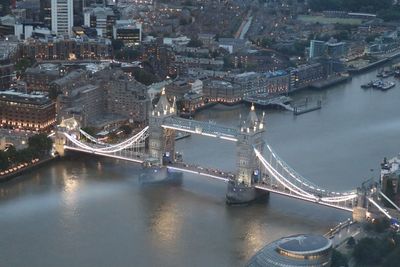High angle view of illuminated bridge over river in city at night