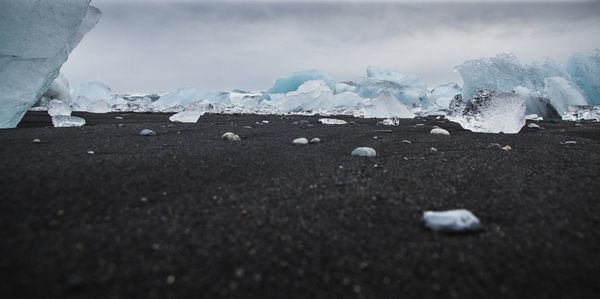 Surface level of frozen landscape against the sky