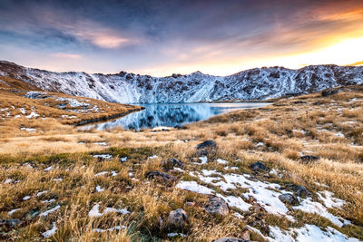 Scenic view of snowcapped mountains against sky during sunset