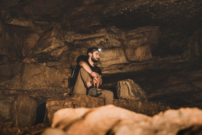 Young couple sitting on rock