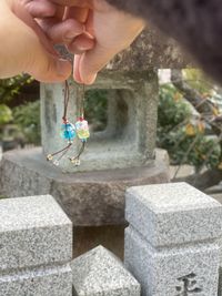 Midsection of person holding stone in cemetery