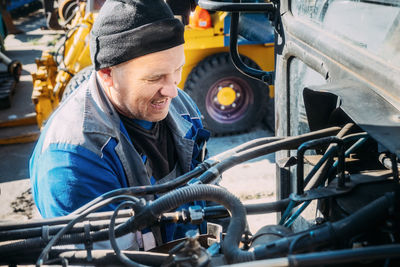 Midsection of man repairing car