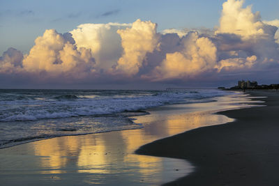 Scenic view of beach against sky during sunset