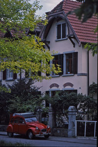 Houses by road against buildings in city