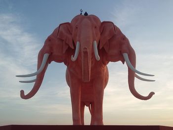 Rear view of elephant standing against sky