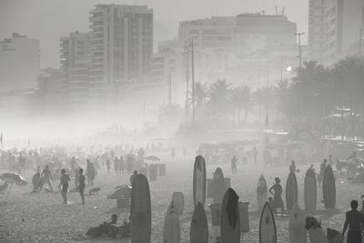 Surfboards at beach against buildings