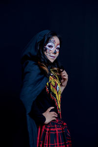 Full length of senior woman standing against black background