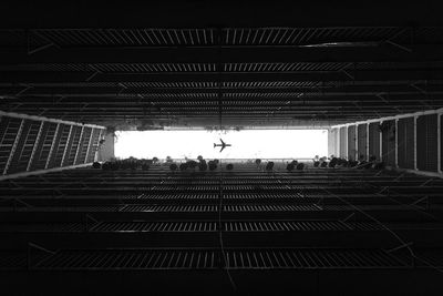 Silhouette people on staircase against sky