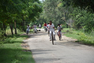 People riding bicycle on road