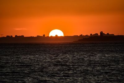 Scenic view of sea against romantic sky at sunset