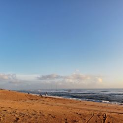 Scenic view of beach against blue sky