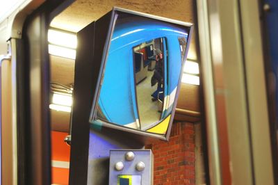 Reflection of person sitting in subway train