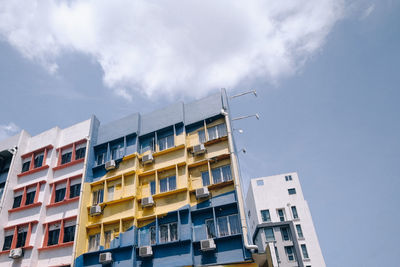 Low angle view of apartment building against sky