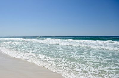 Scenic view of sea against clear blue sky