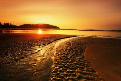 Scenic view of beach against sky during sunset