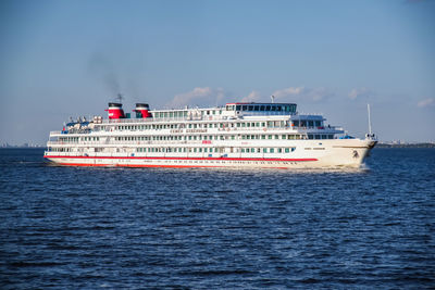 Ship sailing on sea against sky