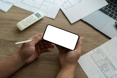 Cropped hands of woman using digital tablet