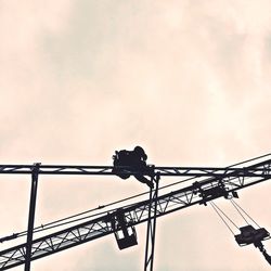 Low angle view of crane against sky