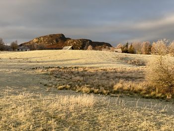 Scenic view of rocks on field against sky