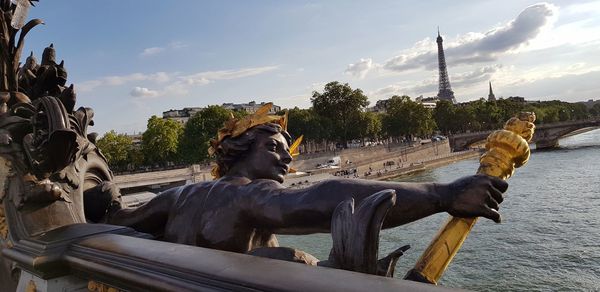 View of horse statue by building against sky