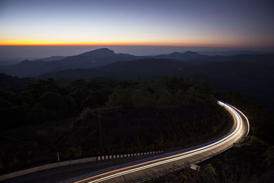 High angle view of light trails on road against sky at night