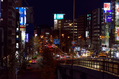 Illuminated city street and buildings at night