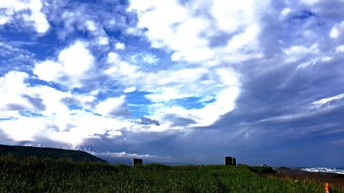 Scenic view of landscape against cloudy sky