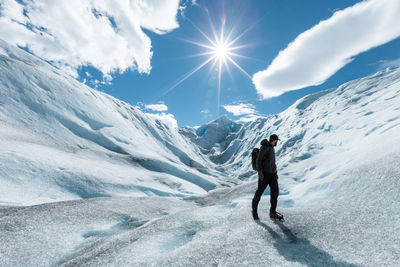 Full length of person on snowcapped mountain against sky