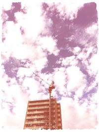 Low angle view of tower against cloudy sky