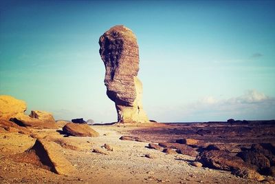 Low angle view of rock formations against blue sky