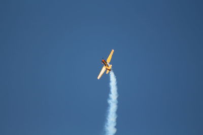 Low angle view of airplane flying in sky