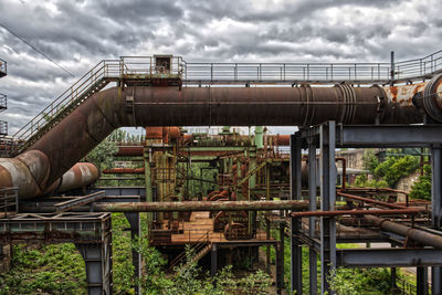 Low angle view of industry against sky