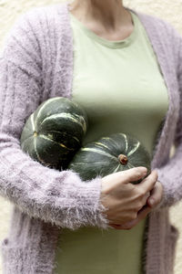 Midsection of woman holding apple