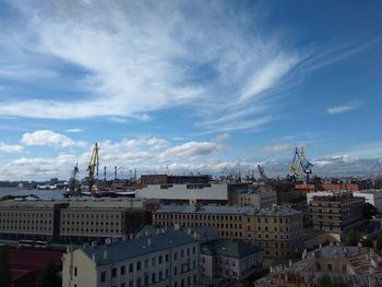 High angle view of city by buildings against sky