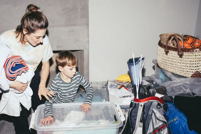 High angle view of son helping mother during relocation of house