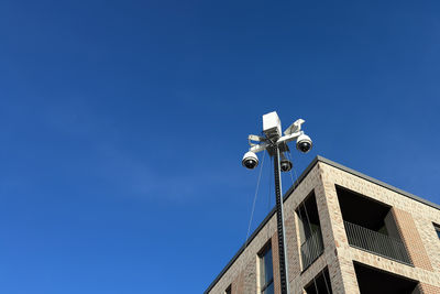 Low angle view of street light against clear blue sky