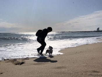 Woman on beach against sky