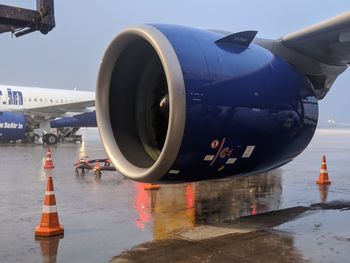 Close-up of airplane on runway against sky