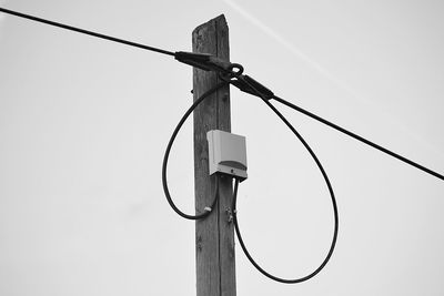 Low angle view of telephone pole against clear sky