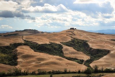 Scenic view of landscape against cloudy sky