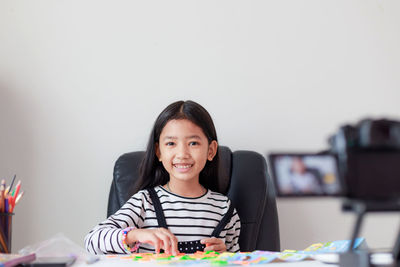 Portrait of a smiling girl on table