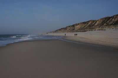 Scenic view of beach against clear sky