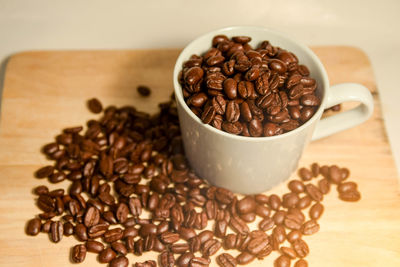 Close-up of coffee beans in glass on table