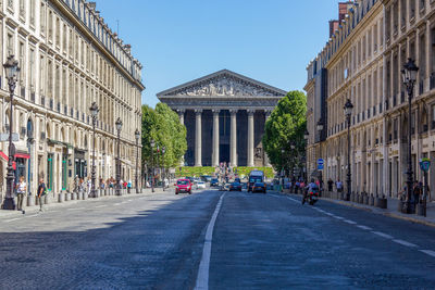 Vehicles on street at church of la madeleine