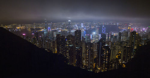 High angle view of illuminated buildings in city at night