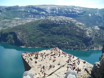 High angle view of rocks by sea against mountains