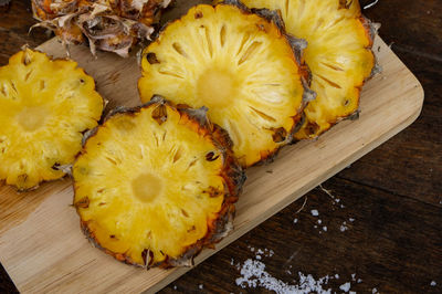 High angle view of pineapple slices on cutting board