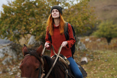 Young woman with a horse